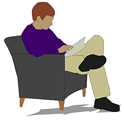 A young man seated in a chair reading a book. 